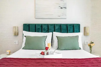 a bedroom with a large bed with a green headboard at MVR - Luxury Tower Stay with Miami Views in Miami