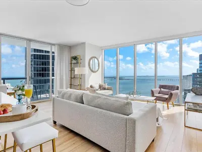 a living room with a couch and views of the ocean at MVR - Bay & City Views from the 45th in Miami