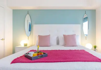 a white bed with a tray of fruit on it at MVR - Soaring Views & Spa Access in Miami