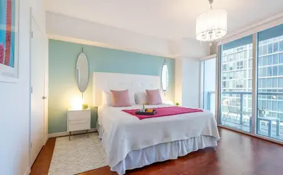 a bedroom with a large bed and a large window at MVR - Soaring Views & Spa Access in Miami