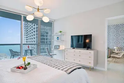 a bedroom with a large bed and a television at MVR - Icon Brickell & King Suite Views in Miami