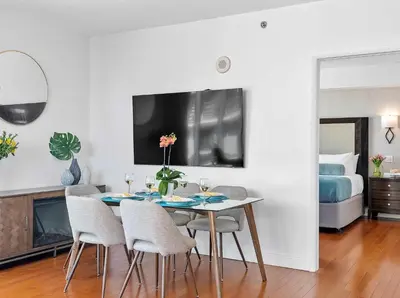 a dining room with a table and chairs and a bed at MVR-The Stay You-ll Talk About All Year in Miami