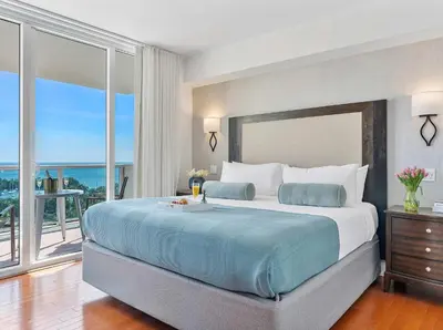 a bedroom with a large bed with a view of the ocean at MVR - Coconut Grove-s Oasis of Comfort and Elegance in Miami