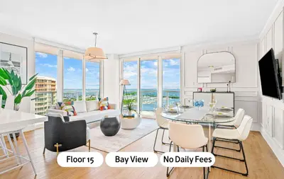 a dining room and living room with a view of the ocean at MVR - Steps from Miami-s Top Attractions in Miami