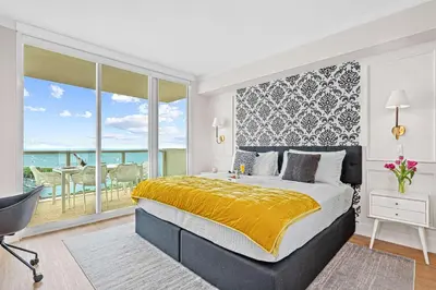 a bedroom with a large bed and a balcony at MVR - Steps from Miami-s Top Attractions in Miami