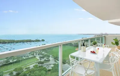 a balcony with a table and chairs and the ocean at MVR - Views You-ll Brag About for Years in Miami