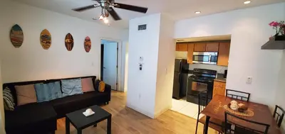 a living room and kitchen with a couch and a table at 1 Bed on Collins Av close to Beach in Miami Beach
