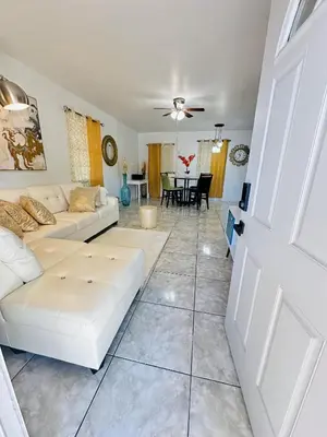 a living room with a white couch and a table at Miami Casa II in Miami Gardens