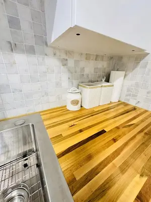 a kitchen with a wooden floor in a room at Miami Casa II in Miami Gardens