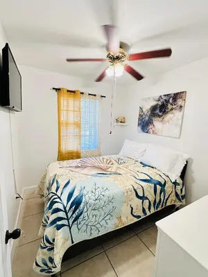 a bedroom with a bed with a ceiling fan at Miami Casa II in Miami Gardens