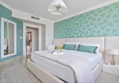 a bedroom with a large white bed with blue walls at MVR - Where Families and Professionals Align in Miami