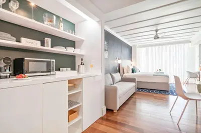 a living room with a couch and a bedroom at MVR-See the City Sparkle-Every Night in Miami