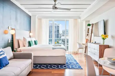 a bedroom with a bed and a couch and a table at MVR-See the City Sparkle-Every Night in Miami