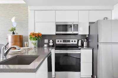 a kitchen with a stove and a microwave at MVR-Sunset Luxury You Can-t Find Anywhere Else in Miami