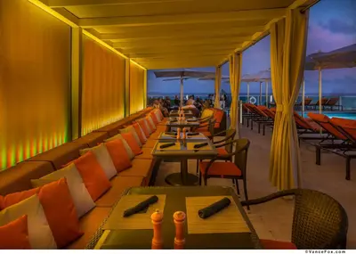 a restaurant with tables and chairs on a balcony at MVR-Sunset Luxury You Can-t Find Anywhere Else in Miami
