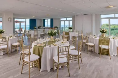 a banquet room with tables and chairs with white tablecloths at MVR-Sunset Luxury You Can-t Find Anywhere Else in Miami