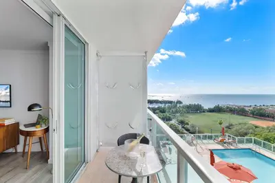 a room with a balcony with a view of the ocean at MVR-Sunset Luxury You Can-t Find Anywhere Else in Miami