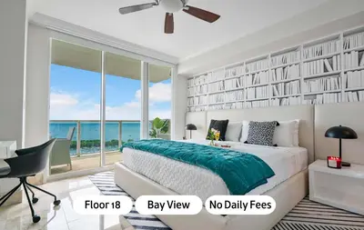 a bedroom with a bed with a view of the ocean at MVR - Longest Rooftop Pool in Florida-Yours in Miami