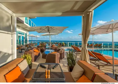 a resort patio with chairs and a swimming pool at MVR-Your Escape Your View Your Grove in Miami