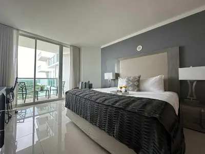 a bedroom with a large bed and a balcony at MVR - Gorgeous Views and Refined Living Spaces in Miami
