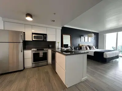 a large kitchen with a bed in a bedroom at MVR-Balcony Apartments Filling Up-Act Now in Miami