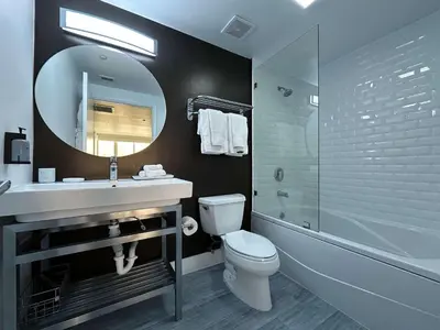 a bathroom with a sink and a toilet and a mirror at MVR-Balcony Apartments Filling Up-Act Now in Miami