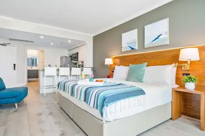 a bedroom with a large bed and a blue chair at MVR - The Best of Work Relaxation in One in Miami