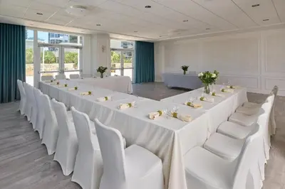 a large room with white tables and white chairs at MVR-Modern Touches Coconut Grove Warmth in Miami
