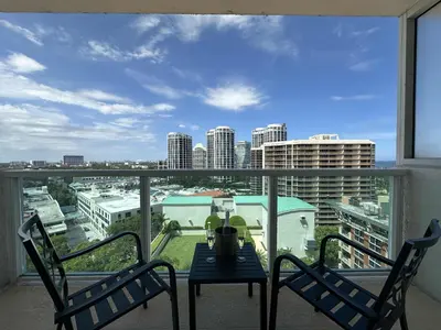 a balcony with a table and chairs and a view of a city at MVR-Modern Touches Coconut Grove Warmth in Miami