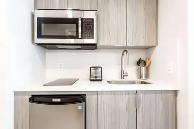 a kitchen with a microwave and a sink at MVR - Wake to Sunrises Toast to Sunsets in Miami