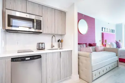 a kitchen and living room with a couch and a microwave at MVR - Wake to Sunrises Toast to Sunsets in Miami