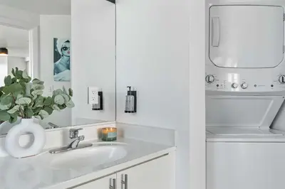a white bathroom with a sink and a mirror at MVR - Designed for Design Lovers Who Travel in Miami