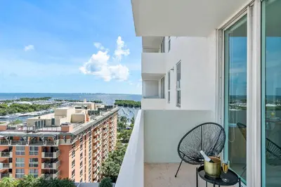 a balcony with a chair and a view of a building at MVR - Designed for Design Lovers Who Travel in Miami