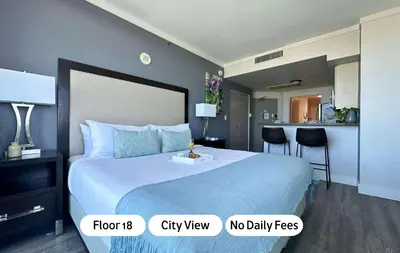 a hotel room with a large bed and a kitchen at MVR - Miami Vibes from Your Balcony Retreat in Miami