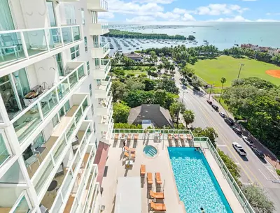 an aerial view of a building with a swimming pool and the ocean at MVR - Elevate Your Stay with Stunning Ocean Views in Miami