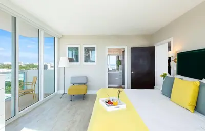 a living room with a yellow couch and a table at MVR-Stop Searching-This Stay Has It All in Miami