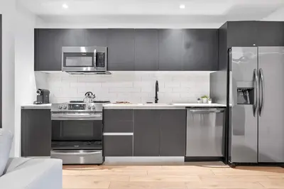 a kitchen with stainless steel appliances and a refrigerator at MVR - Walkable Downtown Gem with Breathtaking Views in Miami