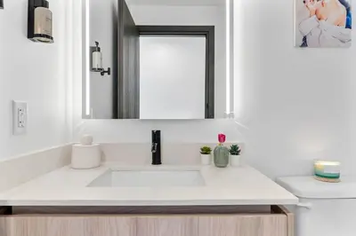 a white bathroom with a sink and a mirror at MVR - Walkable Downtown Gem with Breathtaking Views in Miami