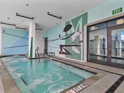 a swimming pool in a building with a mural at MVR - Sunset & Skyline Magic from Your Balcony in Miami