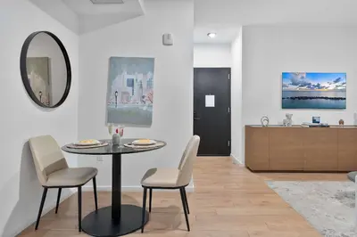 a dining room with a table and chairs and a kitchen at MVR - Sunset & Skyline Magic from Your Balcony in Miami