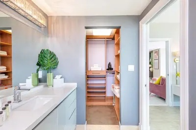 a bathroom with blue walls and a sink and a hallway at MVR - Miami's Most Exclusive Stay-Revealed in Miami