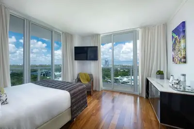 a hotel room with a bed and large windows at MVR - Stay Near Brickell Without the Hassle in Miami