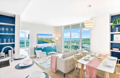 a living room with a table and chairs and a couch at MVR - Your Private Slice of Grove Luxury Awaits in Miami