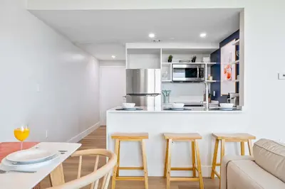 a kitchen and living room with a table and chairs at MVR - Your Private Slice of Grove Luxury Awaits in Miami
