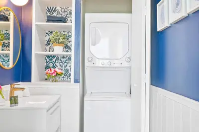 a bathroom with a sink and a washing machine at MVR - Your Private Slice of Grove Luxury Awaits in Miami