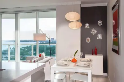 a white dining room with a white table and chairs at MVR - Miami-s Most Exclusive Stay-Revealed in Miami