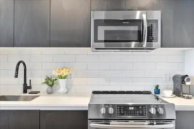 a kitchen with a stove and a microwave at MVR - Swim Relax & Enjoy Jaw-Dropping Views in Miami