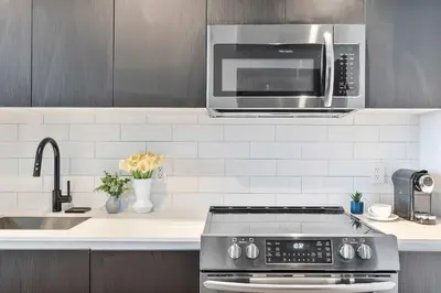 a kitchen with a stove and a microwave at MVR - 5-Star Resort Pool & Private Balcony in Miami