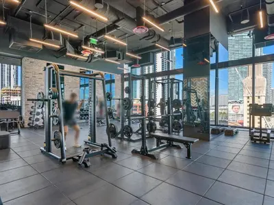 a gym with several tread machines and a person in the background at MVR - 5-Star Resort Pool & Private Balcony in Miami