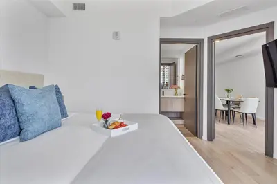 a bedroom with a white bed with a tray of fruit on it at MVR - Best Views in Downtown - Walk Everywhere in Miami
